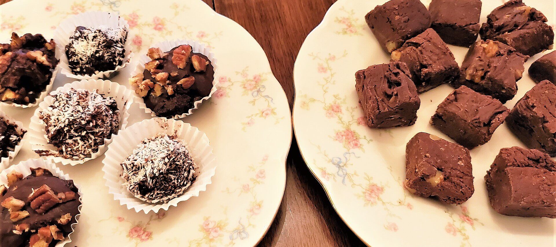 Two round white plates; one holding various chocolate truffles and the other chocolate brownies