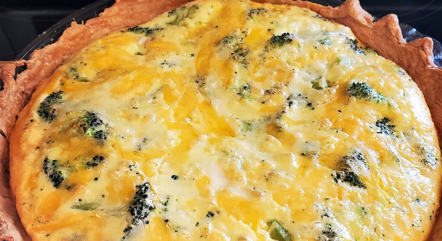 Large round baked egg quiche with a flaky pie crust