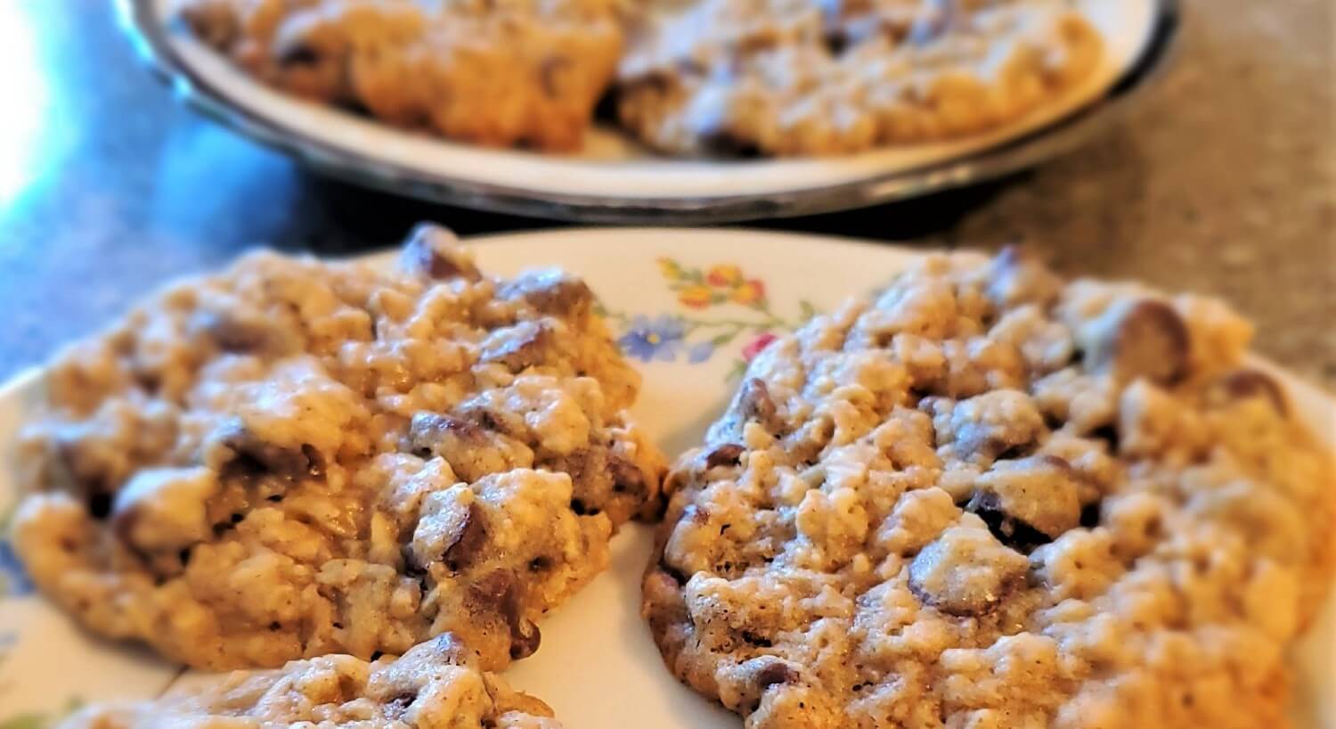 Two round white plates holding several golden brown fresh baked cookies